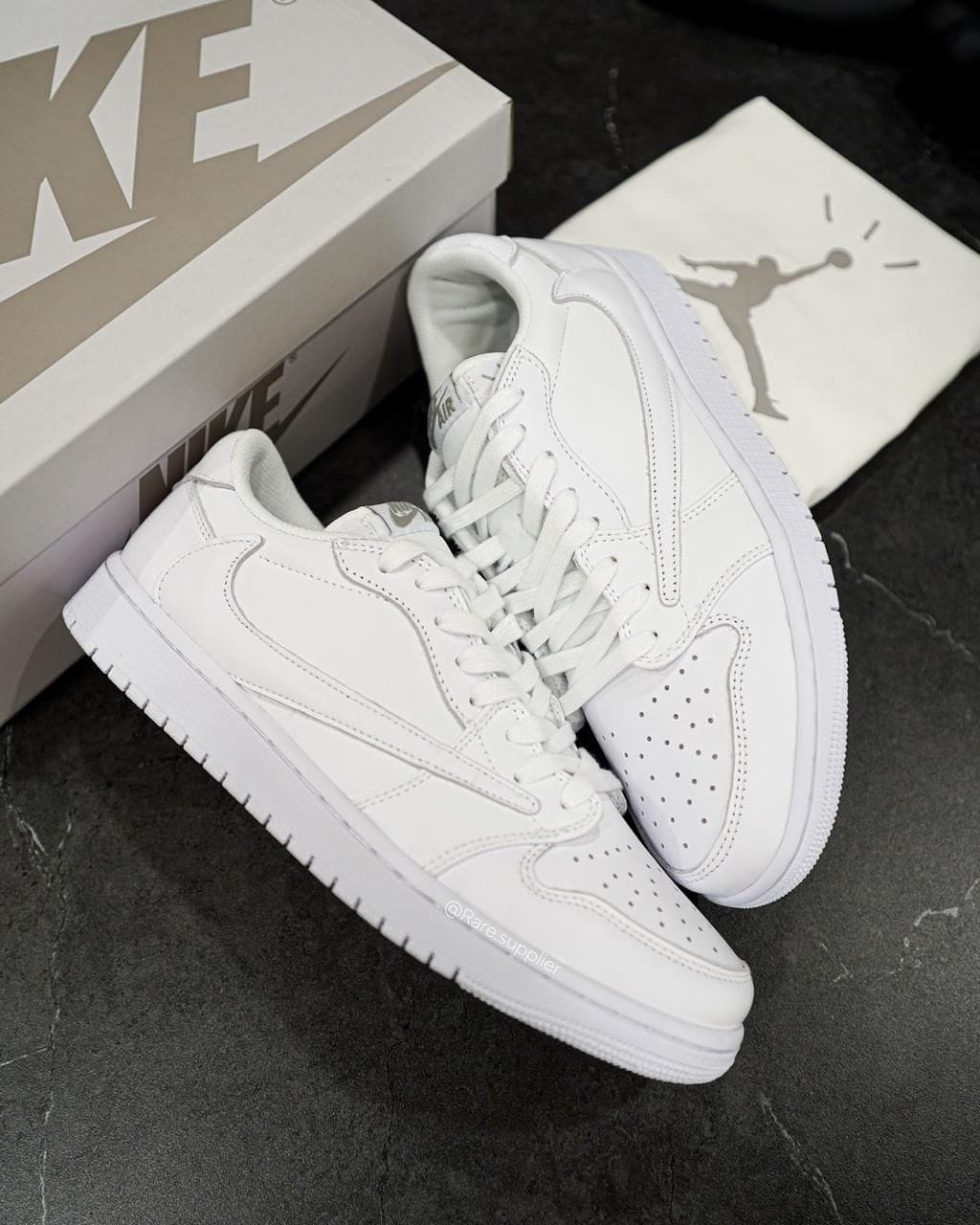 WhatsApp_Image_2024-07-21_at_10.54.47 | UAE SPORT STORE Pair of all-white Nike Air sneakers (Air Force 1) with a matching box on a dark surface; front shoes show perforated toe and clean laces.