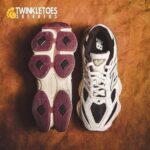 Two running shoes placed side by side on a brown background; left shoe shows a purple outsole with diamond tread, right shoe shows a white/black New Balance upper.