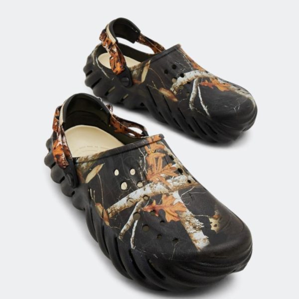 WhatsApp_Image_2024-09-06_at_11.31.54 | UAE SPORT STORE Black camouflage garden clogs with a chunky sole, ventilation holes, and a back strap featuring an autumn leaf print.