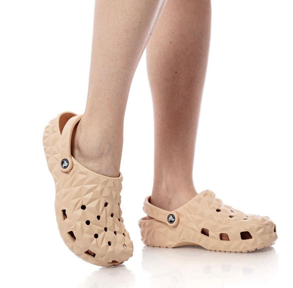 WhatsApp_Image_2024-10-20_at_14.48.50 | UAE SPORT STORE Peach-colored geometric clogs with back strap on a person’s feet.