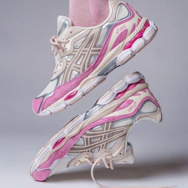 Pair of pink and grey ASICS running shoes stacked midair, showing side and sole details