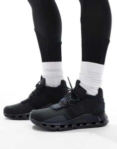 WhatsApp_Image_2024-11-06_at_11.22.24 | UAE SPORT STORE Close-up of black athletic sneakers with white crew socks on feet, lifestyle product shot