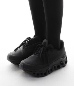 WhatsApp_Image_2024-11-12_at_14.02.57 | UAE SPORT STORE Person wearing black leggings standing in black chunky sneakers on a white surface.