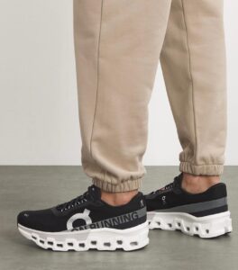 WhatsApp_Image_2024-11-13_at_13.44.15 | UAE SPORT STORE Beige joggers with black On running sneakers featuring a chunky white sole and visible cutouts at the bottom.