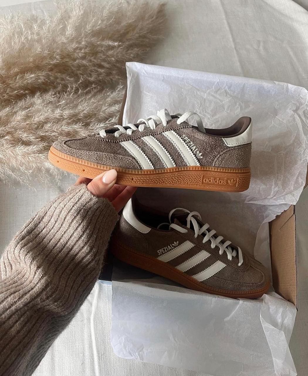 WhatsApp_Image_2024-11-22_at_11.10.46 | UAE SPORT STORE Brown suede Adidas Spezial sneakers with white stripes in an open shoe box.