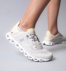 WhatsApp_Image_2024-12-14_at_14.16.17 | UAE SPORT STORE White/cream mesh running shoes with a chunky segmented sole, worn on a person’s feet.