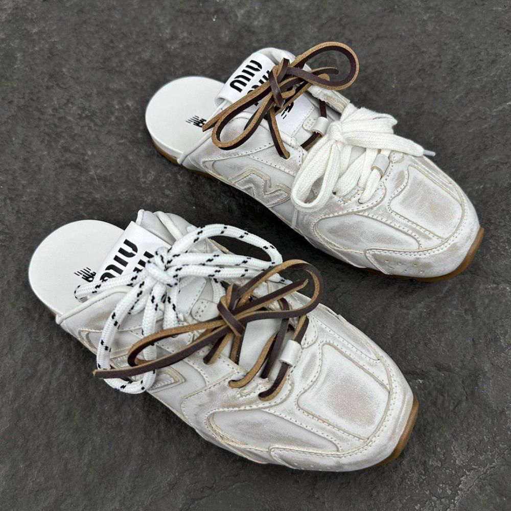 WhatsApp_Image_2024-12-30_at_13.02.32 | UAE SPORT STORE Pair of white chunky sneakers with brown and white laces on a dark asphalt surface.