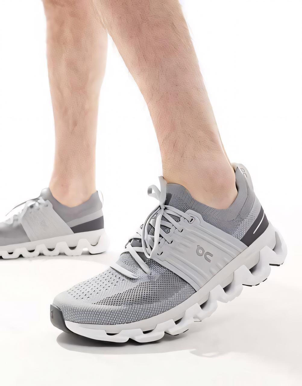 WhatsApp_Image_2025-01-13_at_21.03.03 | UAE SPORT STORE Close-up of gray running shoes with a sculpted white sole on a person's feet