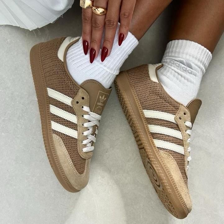 WhatsApp_Image_2025-01-15_at_11.49.08 | UAE SPORT STORE Brown Adidas sneakers with white stripes and white laces, worn with white socks.