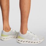 WhatsApp_Image_2025-01-18_at_13.18.07 | UAE SPORT STORE White and light gray running sneakers with lime accents and a hollow-cut sole worn on feet