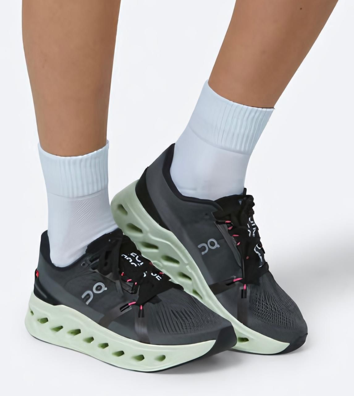 WhatsApp_Image_2025-01-19_at_11.58.42 | UAE SPORT STORE Gray and black running shoes with a lime-green cushioned sole, worn with white crew socks.