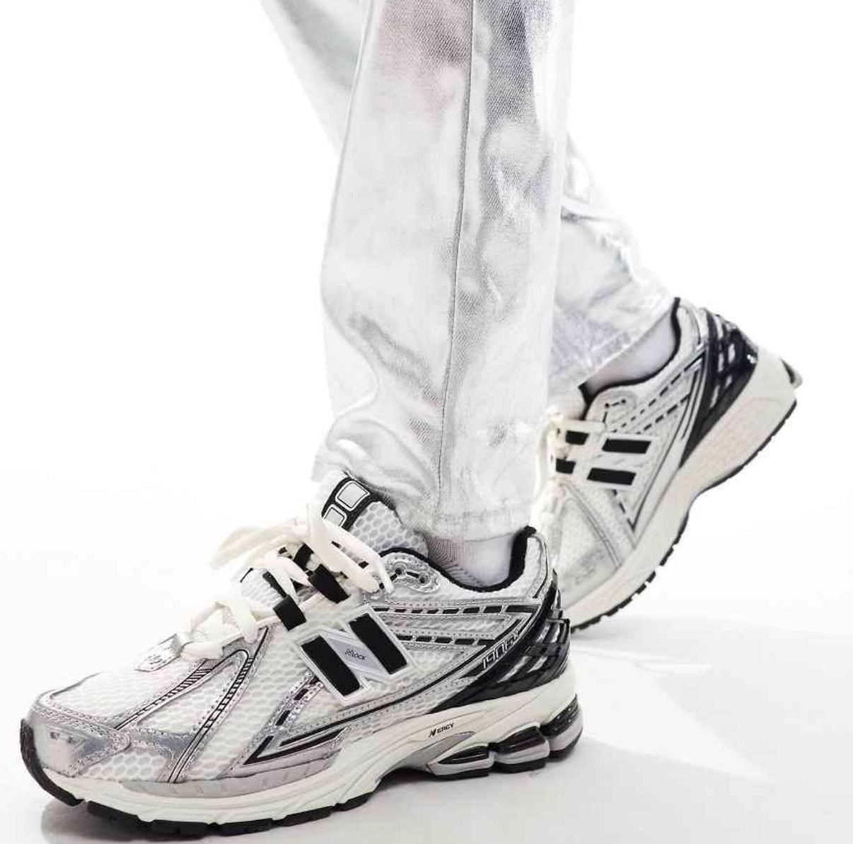WhatsApp_Image_2025-02-13_at_14.22.37 | UAE SPORT STORE Close-up of white and silver running shoes stepping forward, showing the tread and design details on the sneakers.