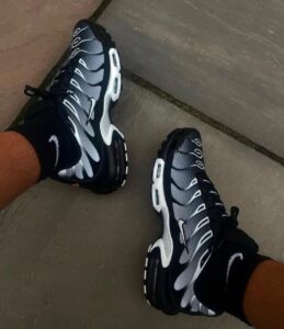 WhatsApp_Image_2025-02-24_at_12.27.35 | UAE SPORT STORE Pair of dark gray and black Nike running shoes with white accents on a tiled floor.