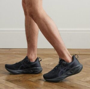 WhatsApp_Image_2025-03-29_at_13.39.49 | UAE SPORT STORE Person walking indoors in black athletic shoes on a wooden floor, mid-step