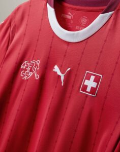 Red Switzerland soccer jersey with white collar, featuring Swiss flag badge on the chest and Puma logo.