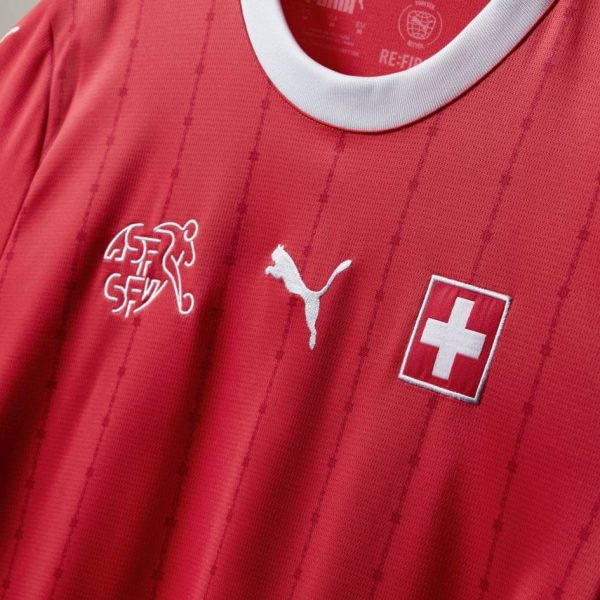 Red Switzerland soccer jersey with white collar, featuring Swiss flag badge on the chest and Puma logo.