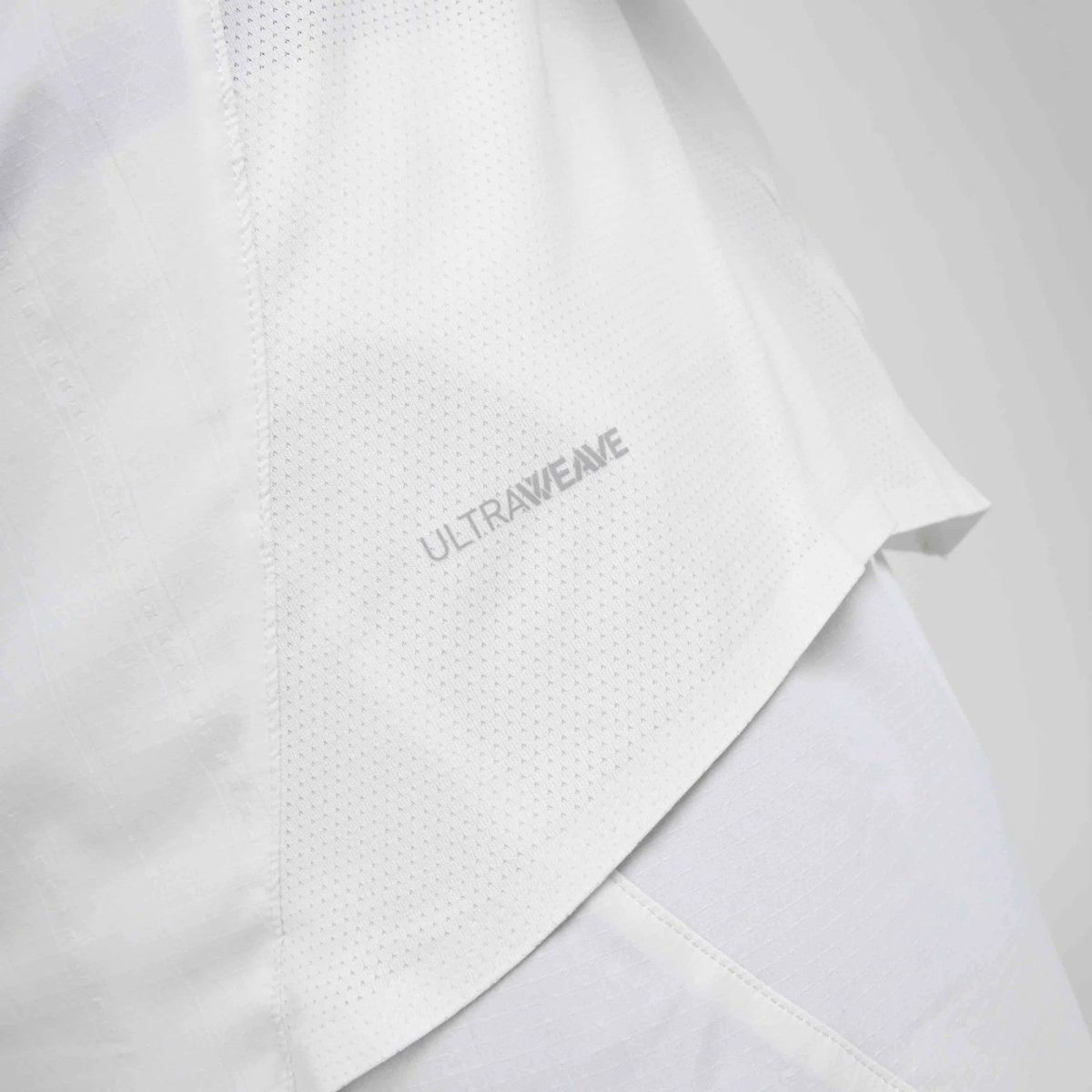 Close-up of white perforated fabric on a garment with subtle 'ULTRAVANE' branding.