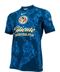 XgL9KkeSTdT7BSL | UAE SPORT STORE Blue soccer jersey with Club América crest and 'Valiente caliente.mx' sponsor, short sleeves, abstract pattern in lighter blue.