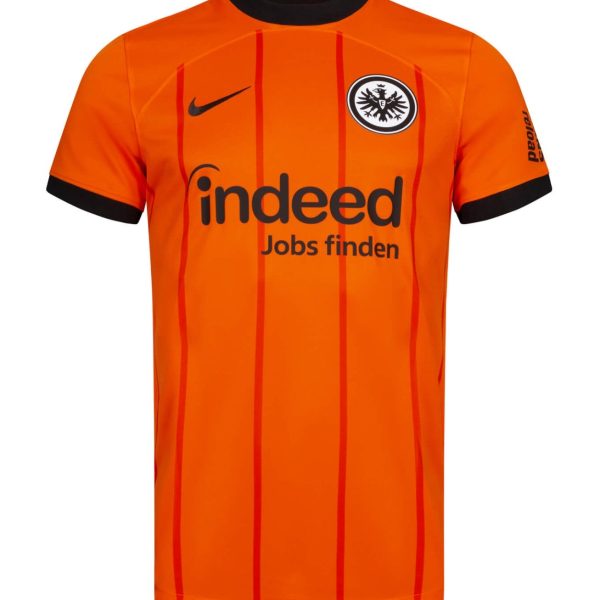 Orange football jersey with black trim, featuring sponsor text 'indeed' and a black‑eagle crest on the chest (Nike logo on left).