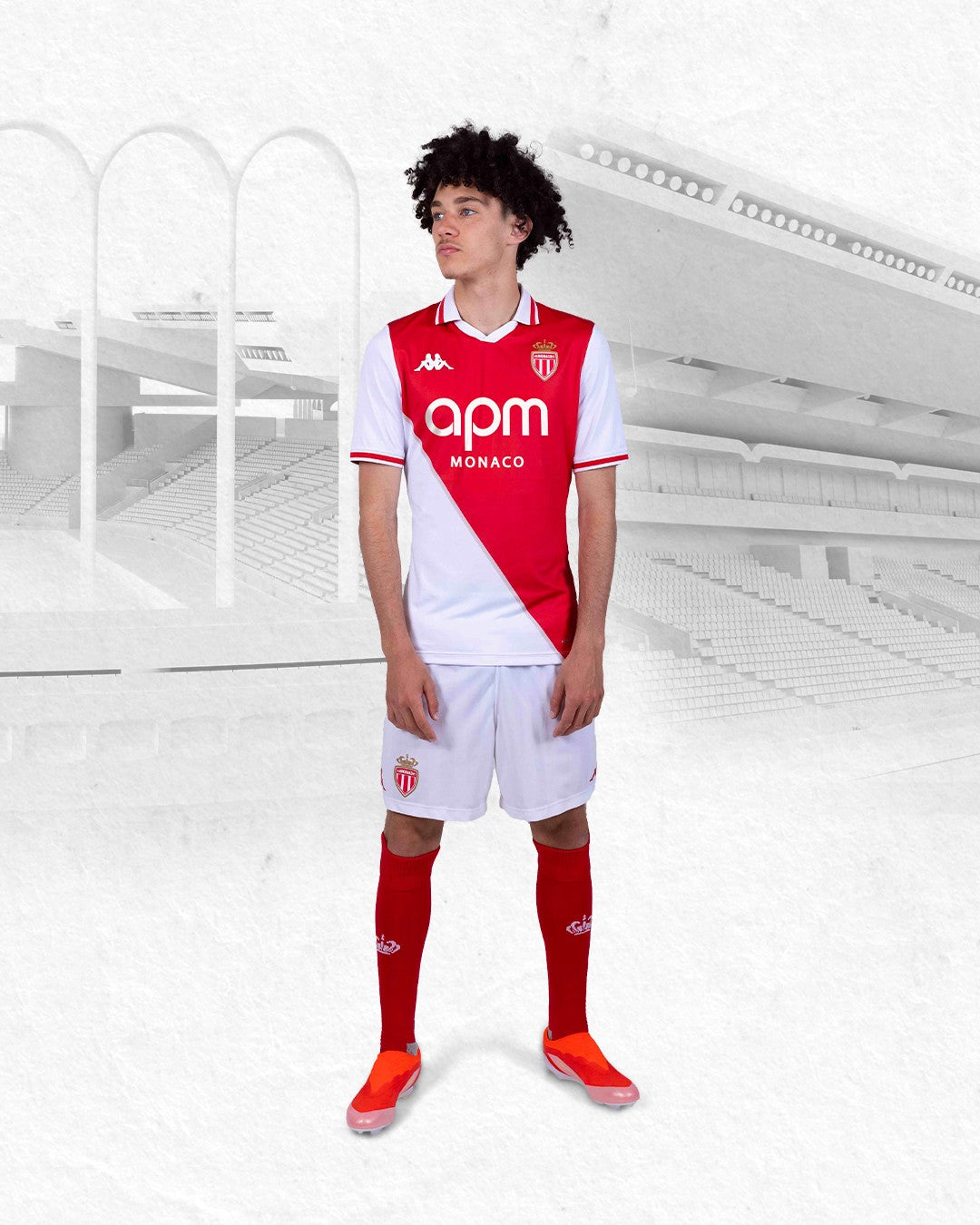 Y9IWyvWvNBF49Ht | UAE SPORT STORE Young male soccer player in Monaco's red-and-white home kit posing in a pale stadium backdrop.