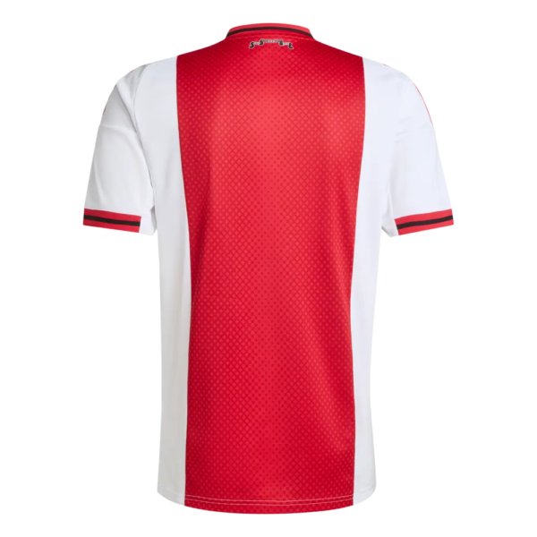 Back of a red and white soccer jersey with a central red honeycomb panel, white sides, and red/black cuff stripes on the sleeves.