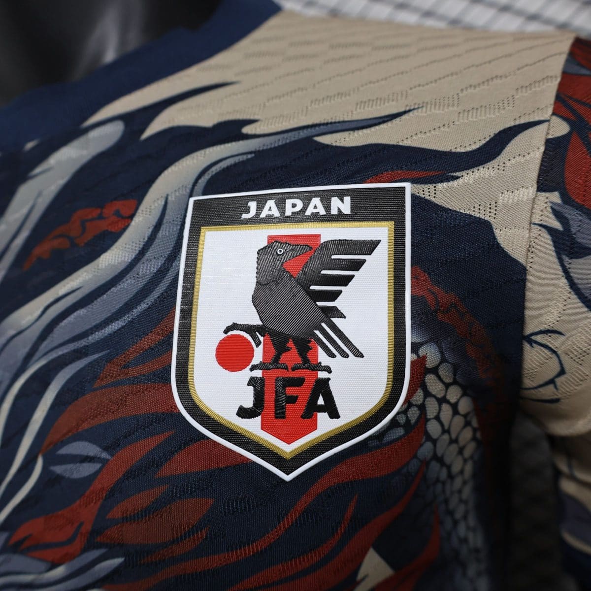 Close-up patch reading 'JAPAN' with an eagle emblem on camo fabric.