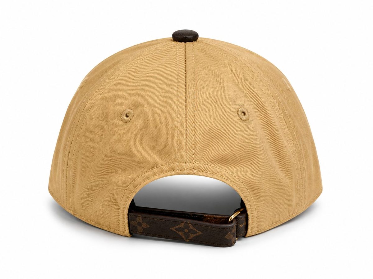 Back view of a tan baseball cap with an adjustable strap at the rear and a Louis Vuitton–patterned buckle