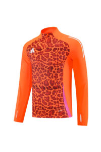 Bright orange long-sleeve athletic top with a leopard-print front, white stripes on the sleeves, pink side panel, and a zip collar.