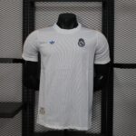 a1ca8dea | UAE SPORT STORE White Real Madrid soccer jersey on a black mannequin, crest visible on left chest and blue Adidas logo on the right, orange piping along shoulders, store display rack in background