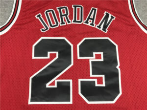 Close-up of a red basketball jersey with 'JORDAN' on the back and the number 23 in black with white trim.