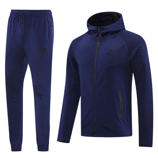 Navy blue Nike jogger pants and matching zip-up jacket shown side by side in a sporty tracksuit set, with Nike logos visible on both pieces.
