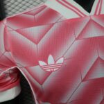 a2f2b271-14f8-4d6e-be5e-e2f7171e7a97 | UAE SPORT STORE Pink geometric-pattern athletic top with a white Adidas trefoil logo in the center