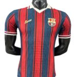 Barcelona football jersey on a mannequin with red and blue vertical stripes and the club crest on the left chest.