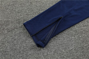 a409ffd7_1024x1024_2x_6817687f-003e-4900-9b85-76e300b16529 | UAE SPORT STORE Navy blue pant leg with an ankle zipper on a gray carpeted floor