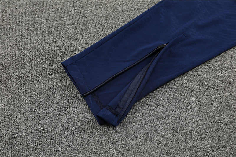 a409ffd7_1024x1024_2x_6817687f-003e-4900-9b85-76e300b16529 | UAE SPORT STORE Navy blue pant leg with an ankle zipper on a gray carpeted floor