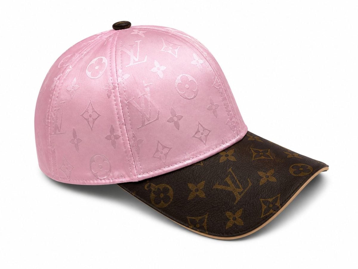 Pink Louis Vuitton baseball cap with a brown curved brim and subtle LV monogram on the crown.