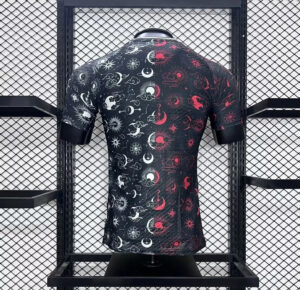 Black short-sleeve shirt with white and red sun, moon, and star patterns on a mannequin in a metal grid display.