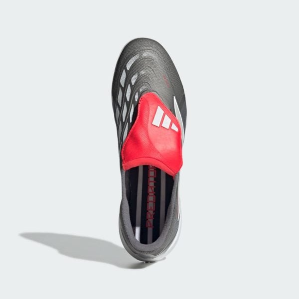 Top-down view of a gray Adidas athletic shoe with a red tongue and white stripes, showing a textured mesh upper.