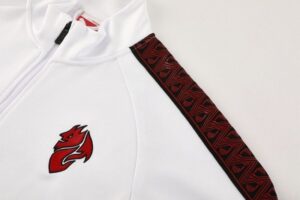White zip-up athletic jacket featuring a red flame logo on the left chest and a red patterned stripe along the sleeve.