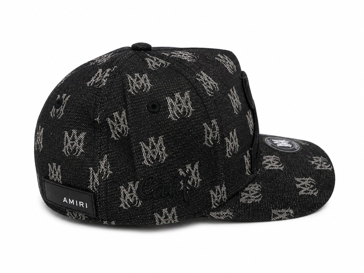 a6714065-e29f-4c89-9879-ecd6889720af | UAE SPORT STORE Black denim cap with a repeating white logo pattern and an Amiri label on the back, curved brim with a circular patch on the top.