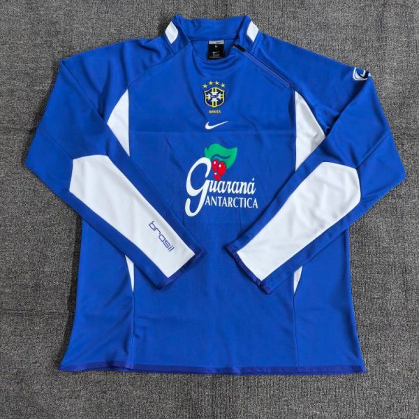 Blue Brazilian national team long-sleeve training jersey with white panels and Guaraná Antarctica sponsor logo on the chest, Nike emblem above, laid flat on a gray surface.