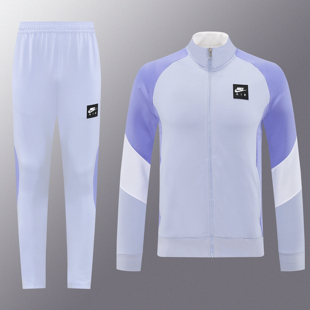 a9edad6b | UAE SPORT STORE Light lavender Nike Air tracksuit: zip-front jacket with color-block panels and matching pants with small black Nike Air logo patches.