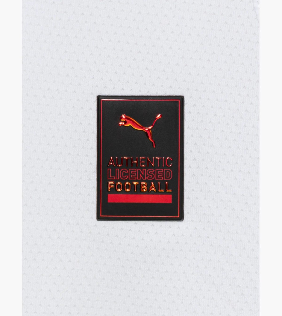 Black patch with red, metallic lettering reading 'AUTHENTIC LICENSED FOOTBALL' and a leaping red Puma logo on white fabric background.] , ...