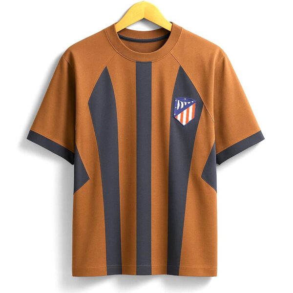 Brown T-shirt with bold dark blue vertical stripes and a small shield emblem on the chest, on a wooden hanger
