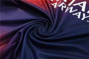aae7c923_1024x1024_2x_a8cec559-d310-48ec-8fad-b7bd8e6bd4bd | UAE SPORT STORE Close-up of a silky fabric twisted into a spiral with navy-to-purple tones and partial white lettering in the corner.