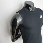 Black Nike sleeveless shirt on a glossy chrome mannequin torso; product display.