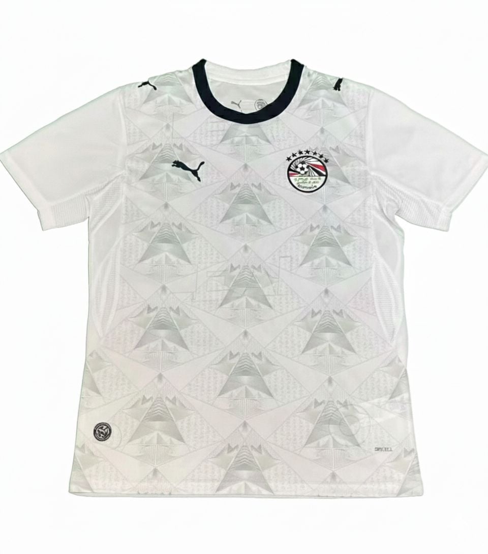abcdce36-0877-401b-9386-8cff62f83669 | UAE SPORT STORE White athletic jersey with geometric silver pattern, black collar, and Puma logos on chest and shoulder; crest on left chest and small emblem near hem.