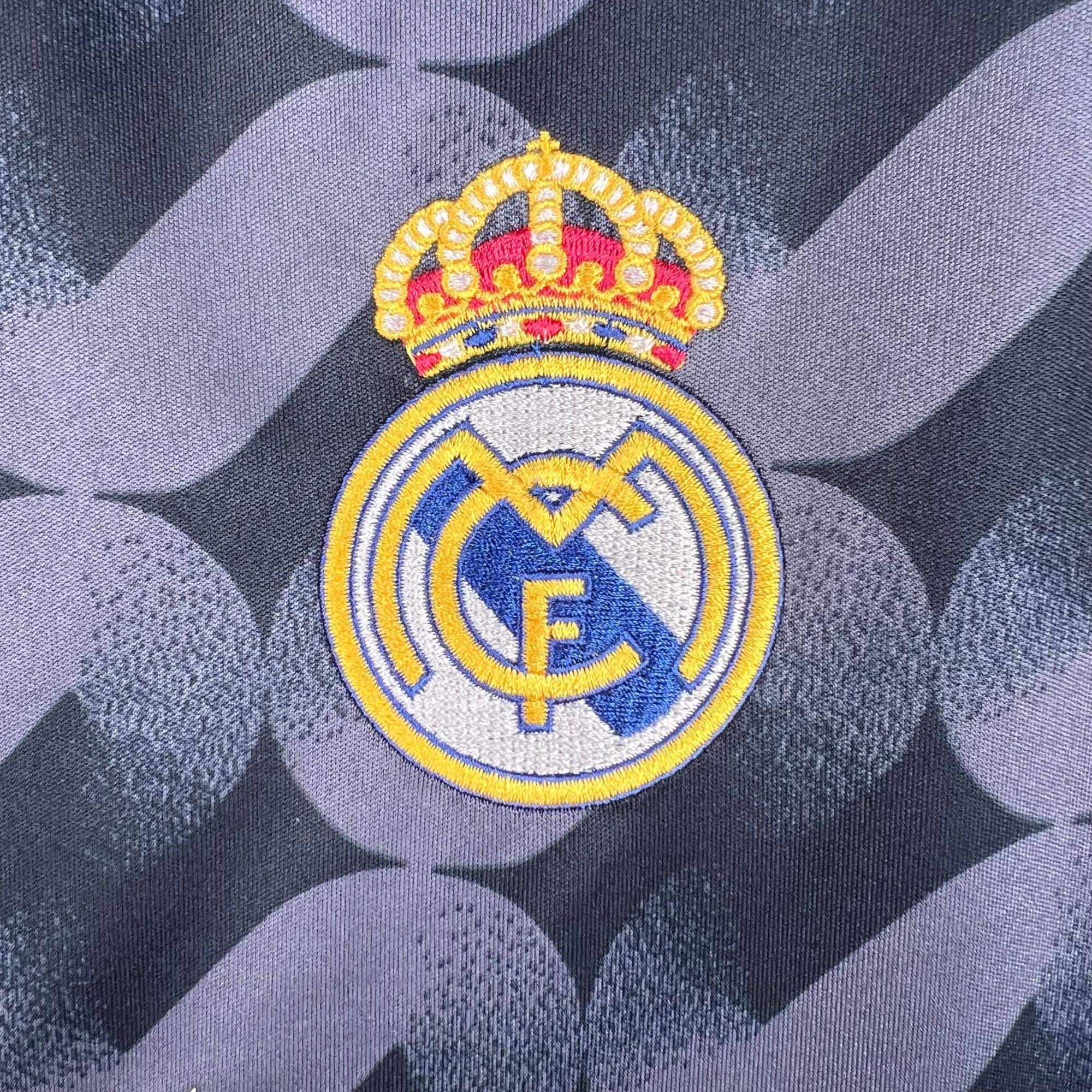 ac3c9e0a | UAE SPORT STORE Close-up of an embroidered crown badge on dark denim fabric
