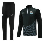 Black training tracksuit with Newcastle United crest and Castore logo—the pants and a long-sleeve zip-top with a geometric pattern on the lower front.