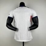 Back view of a white patterned sports jersey on a black mannequin torso, small French flag at the neckline.